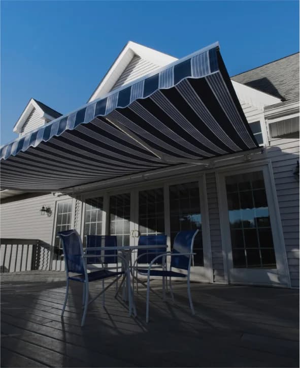 SunPro retractable awning extended over a residential deck with outdoor seating.