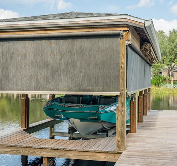 SunPro open-roller shade screens screening a waterfront boat dock from the sun.